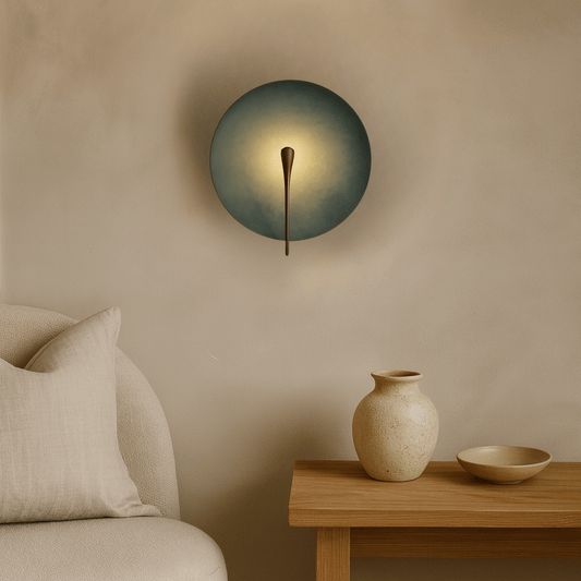 Modern wall light fixture on a beige wall with a wooden side table and decorative items.