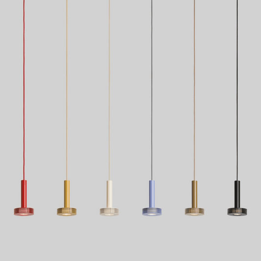 Five pendant lights in different colors hanging against a gray background