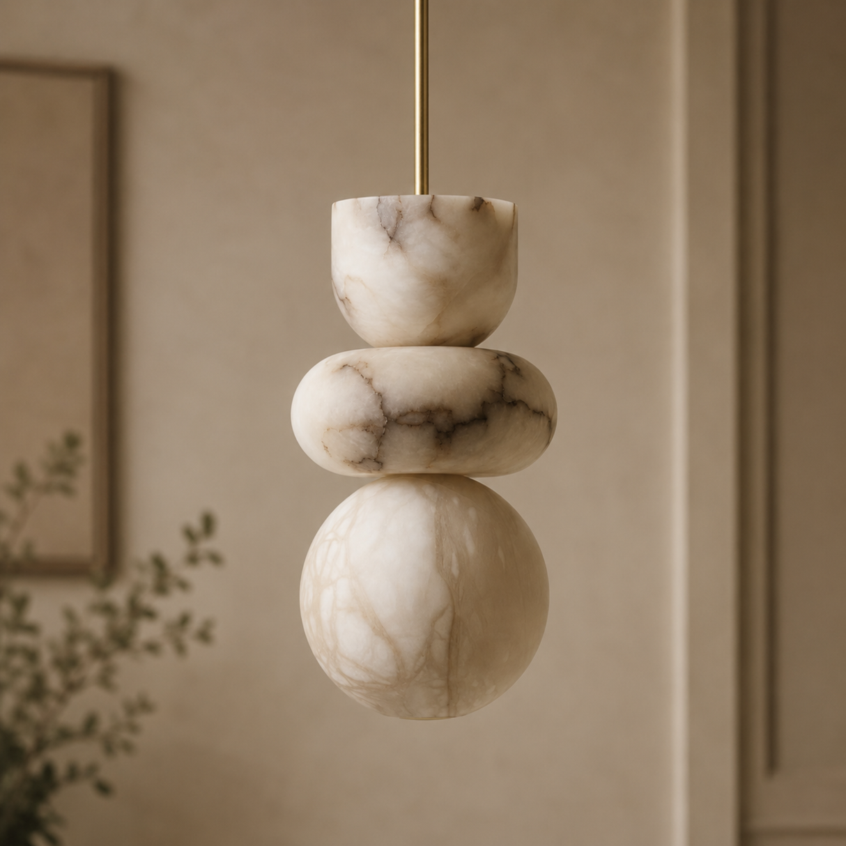 Marble pendant light with gold fixture against a beige wall