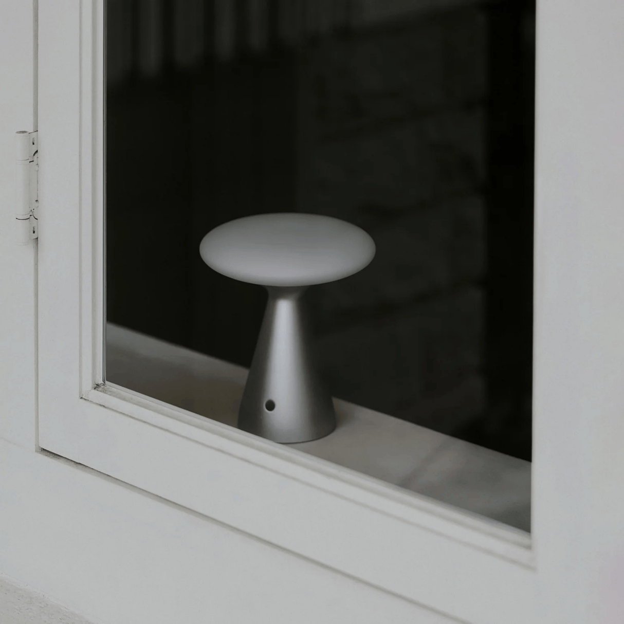 Small white stool reflected in a window