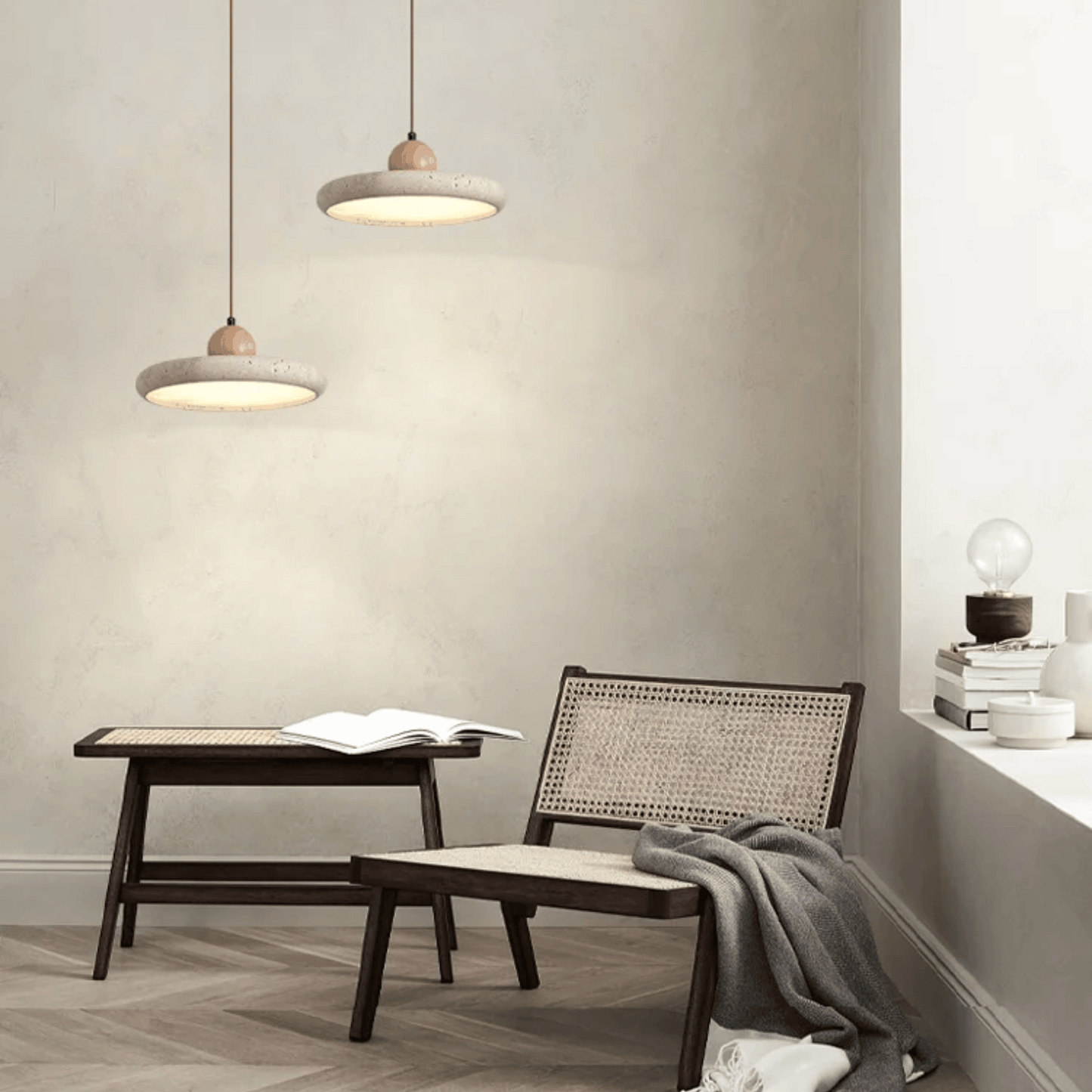 Modern interior with a table, chair, and pendant lights in a neutral setting