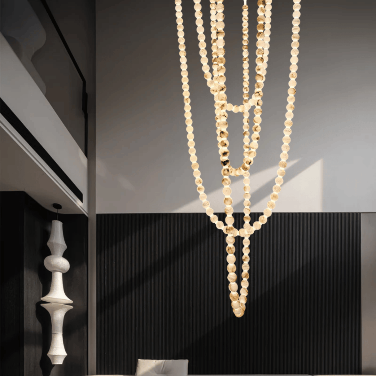 Gold necklace hanging against a dark background