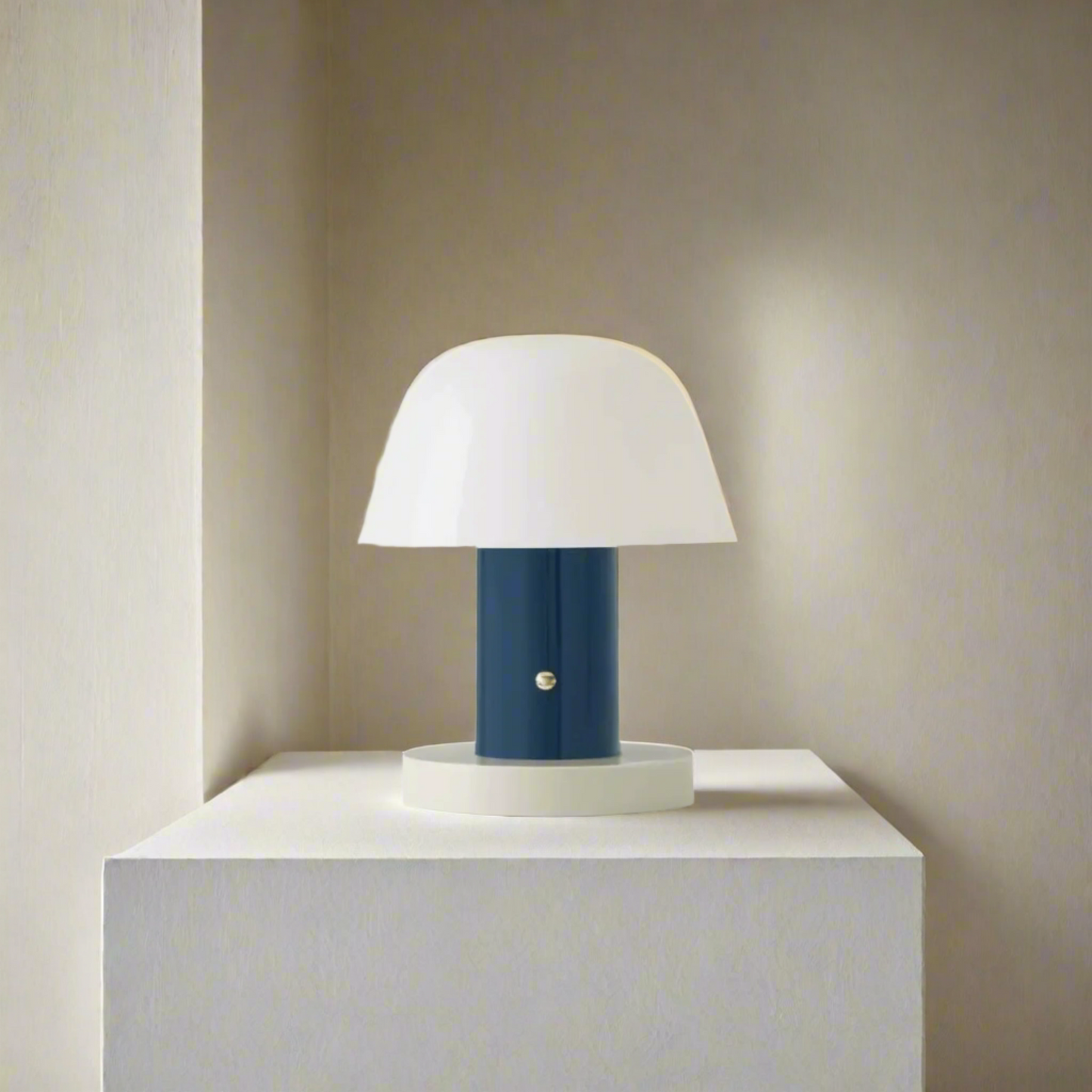 Table lamp with white shade and blue base on a light beige background
