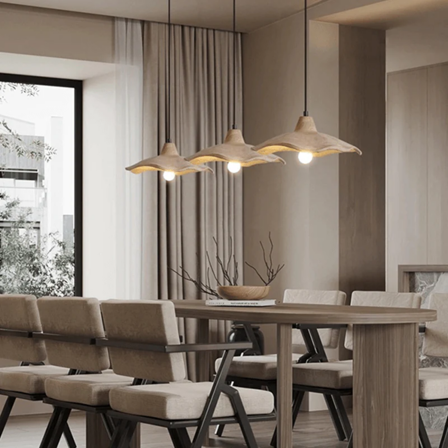 Modern dining room with wooden table and chairs, and pendant lights.