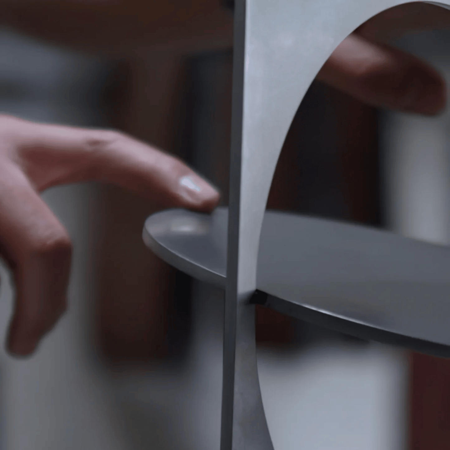 Close-up of a hand interacting with a metallic object