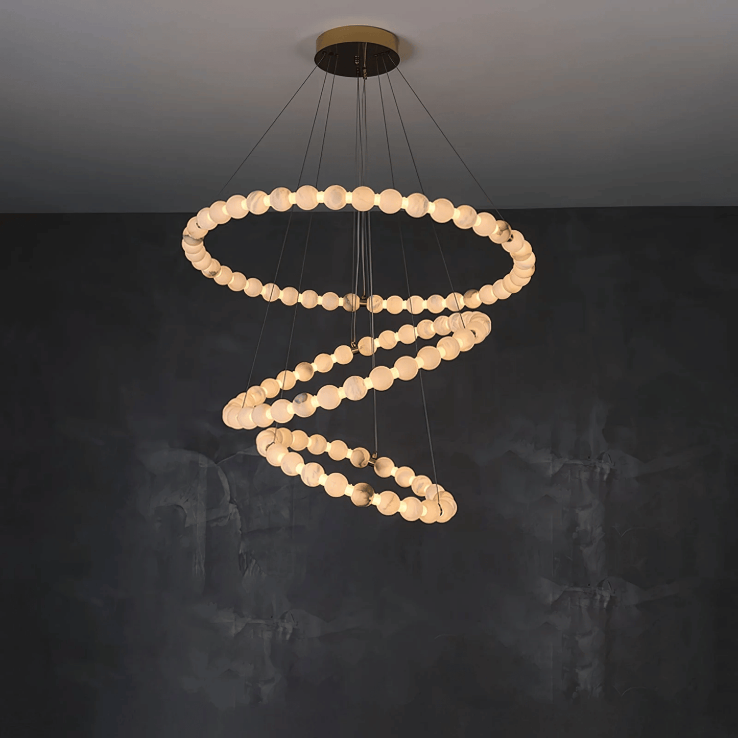 Spiral chandelier with circular lights on a dark background