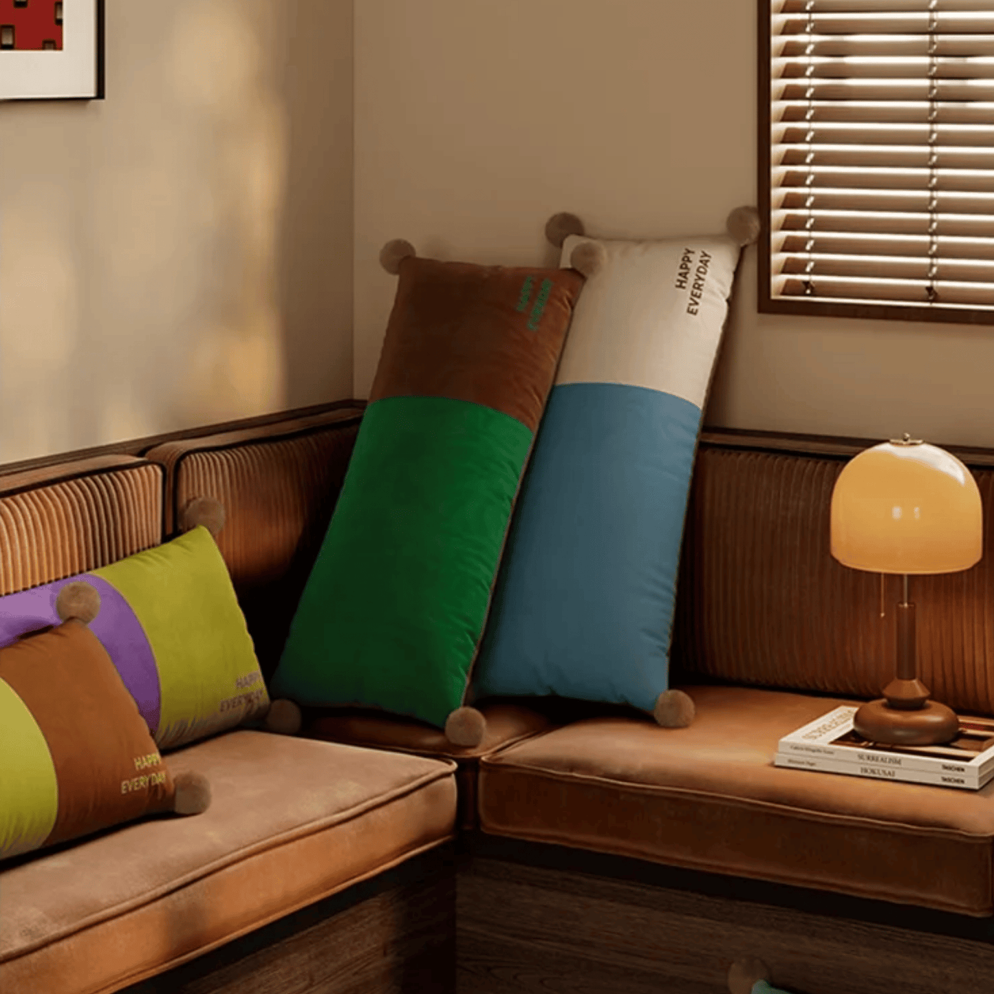 Brown sofa with colorful cushions and a lamp in a cozy room.