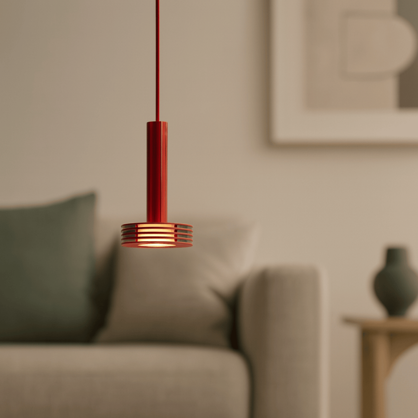 Red pendant light hanging in a living room with a blurred background