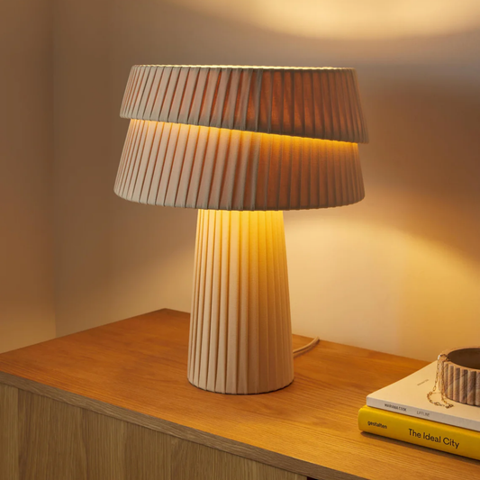 Table lamp with pleated design on a wooden surface