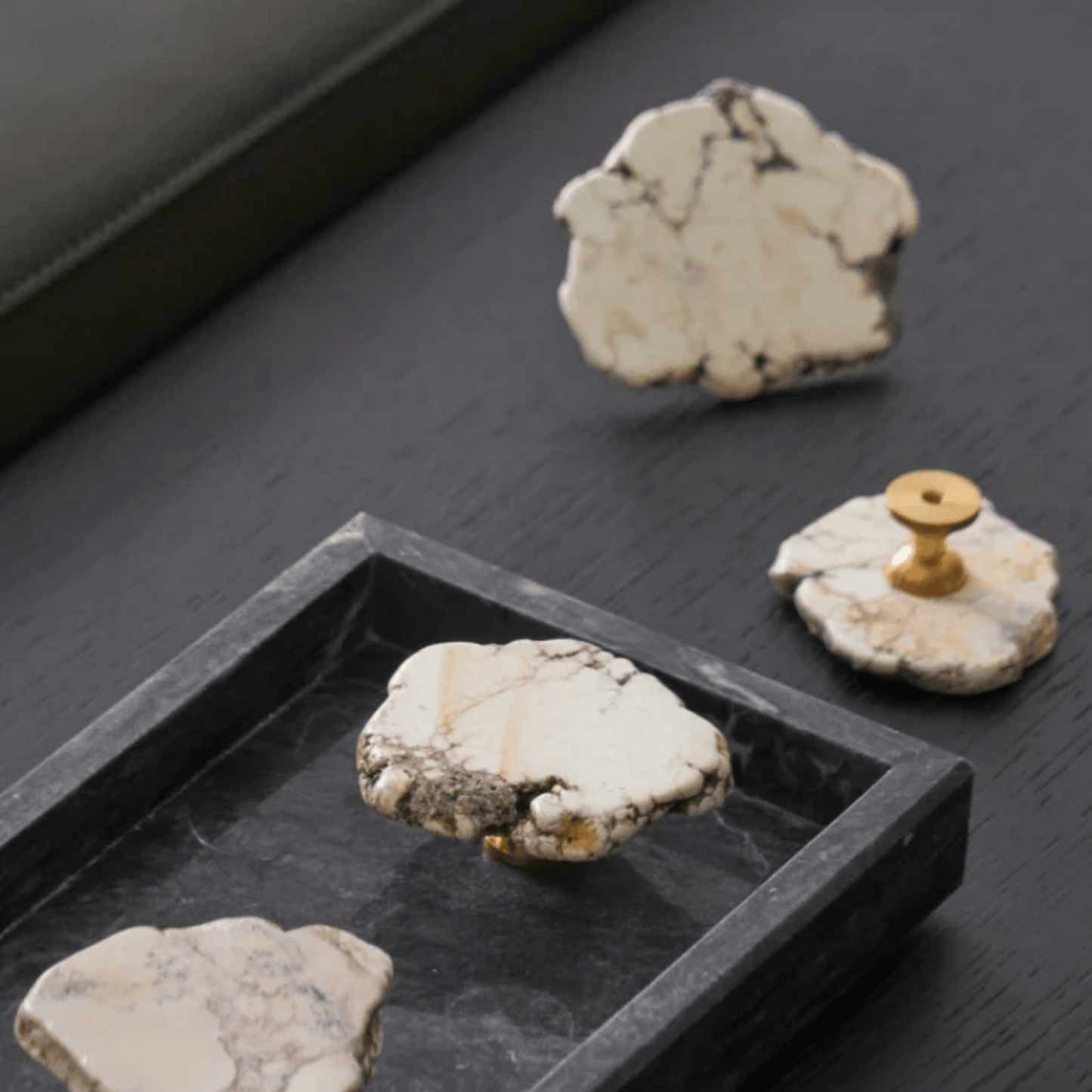 Decorative stones with gold accents on a dark surface