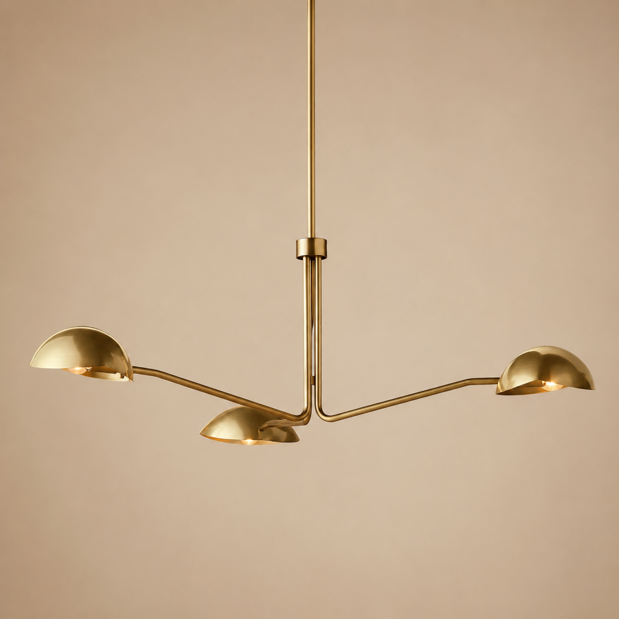 Gold chandelier with three arms on a beige background