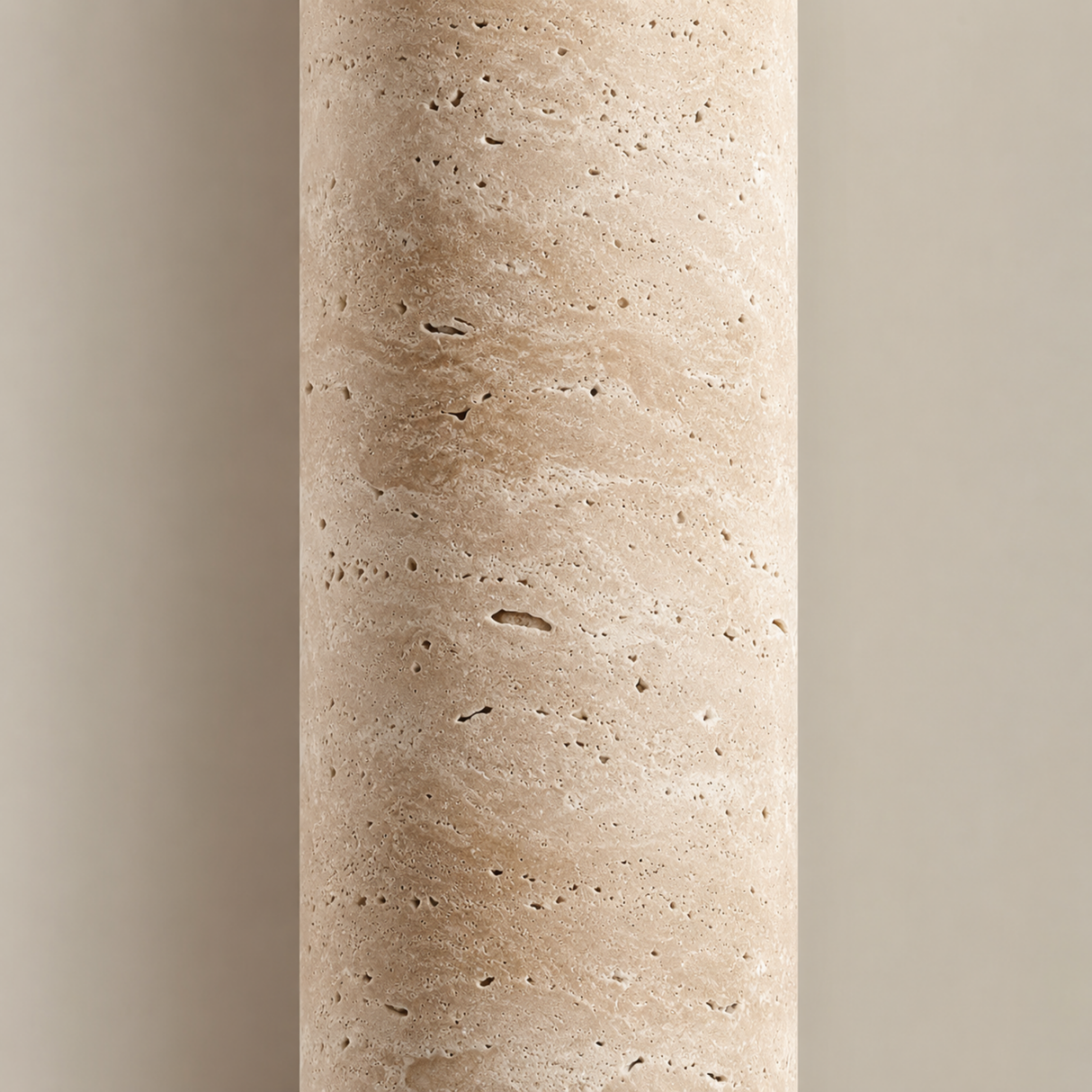 Close-up of a cylindrical stone-like object with a textured surface on a gradient background.