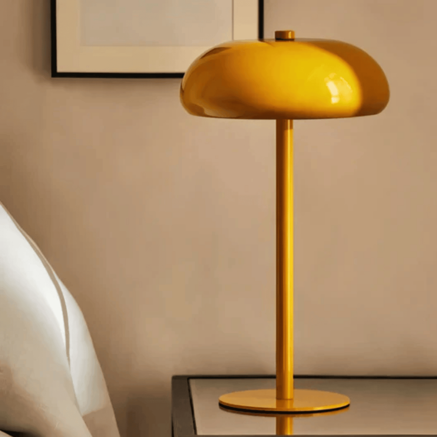 Yellow table lamp on a side table against a beige wall.