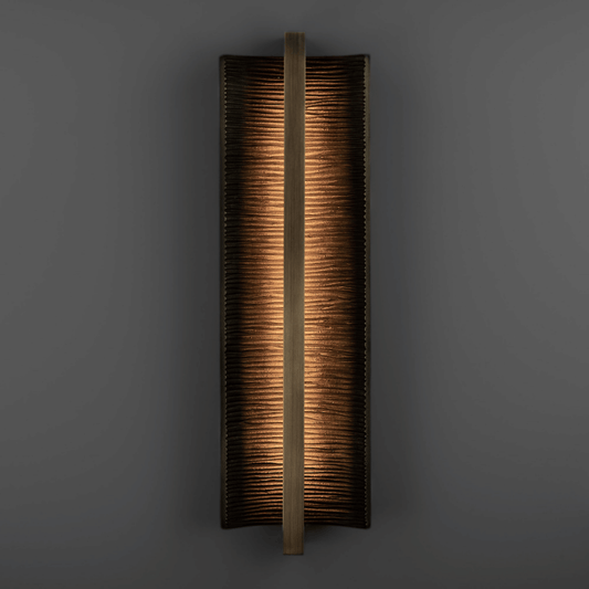 Rectangular wall sconce with a textured finish on a dark background