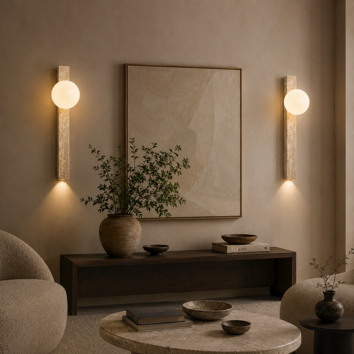 Living room with wall sconces, a framed picture, and decorative items on a coffee table.