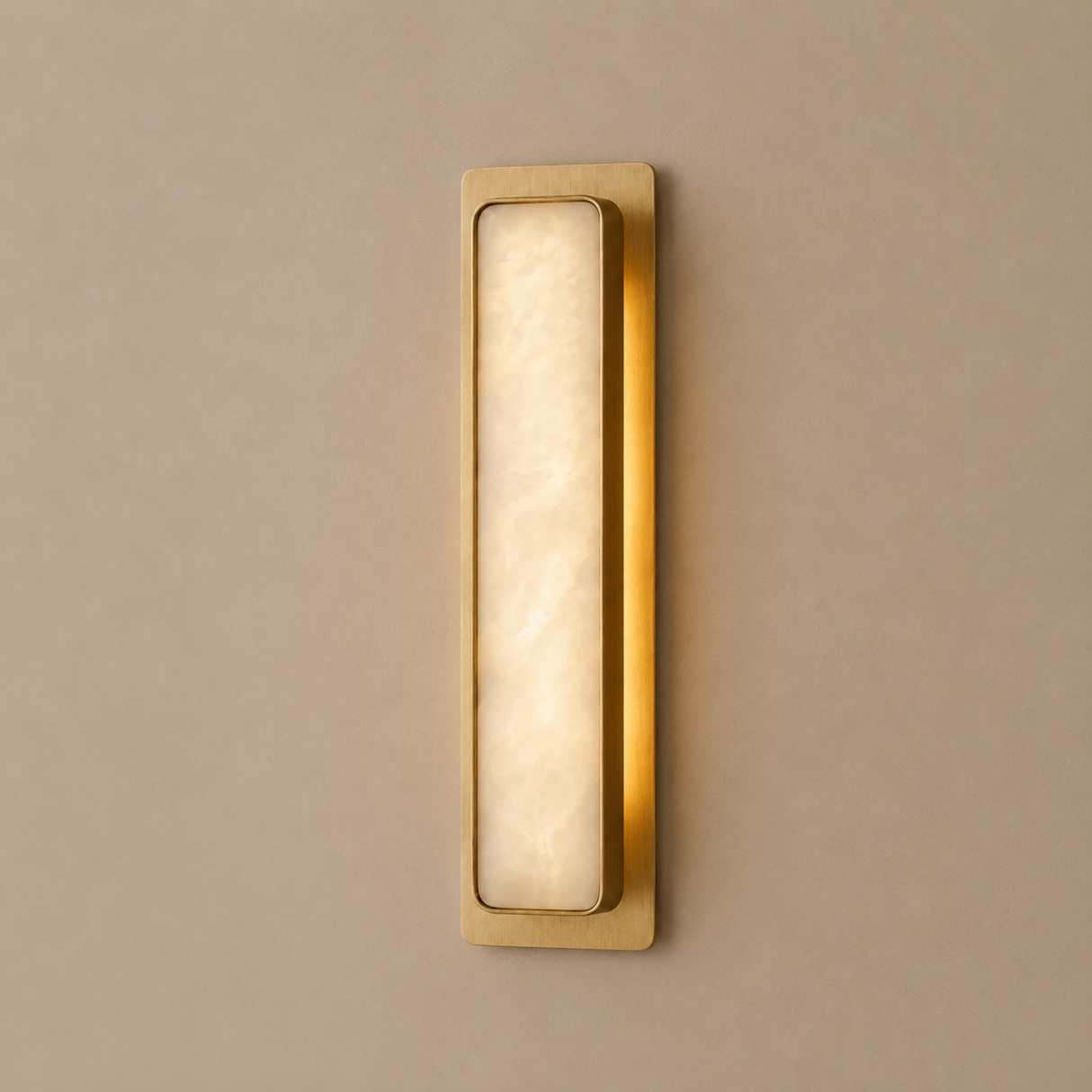 Gold wall sconce with a beige light fixture on a beige wall