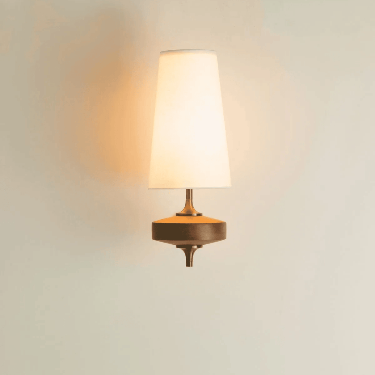 Wall-mounted lamp with a warm glow on a light background