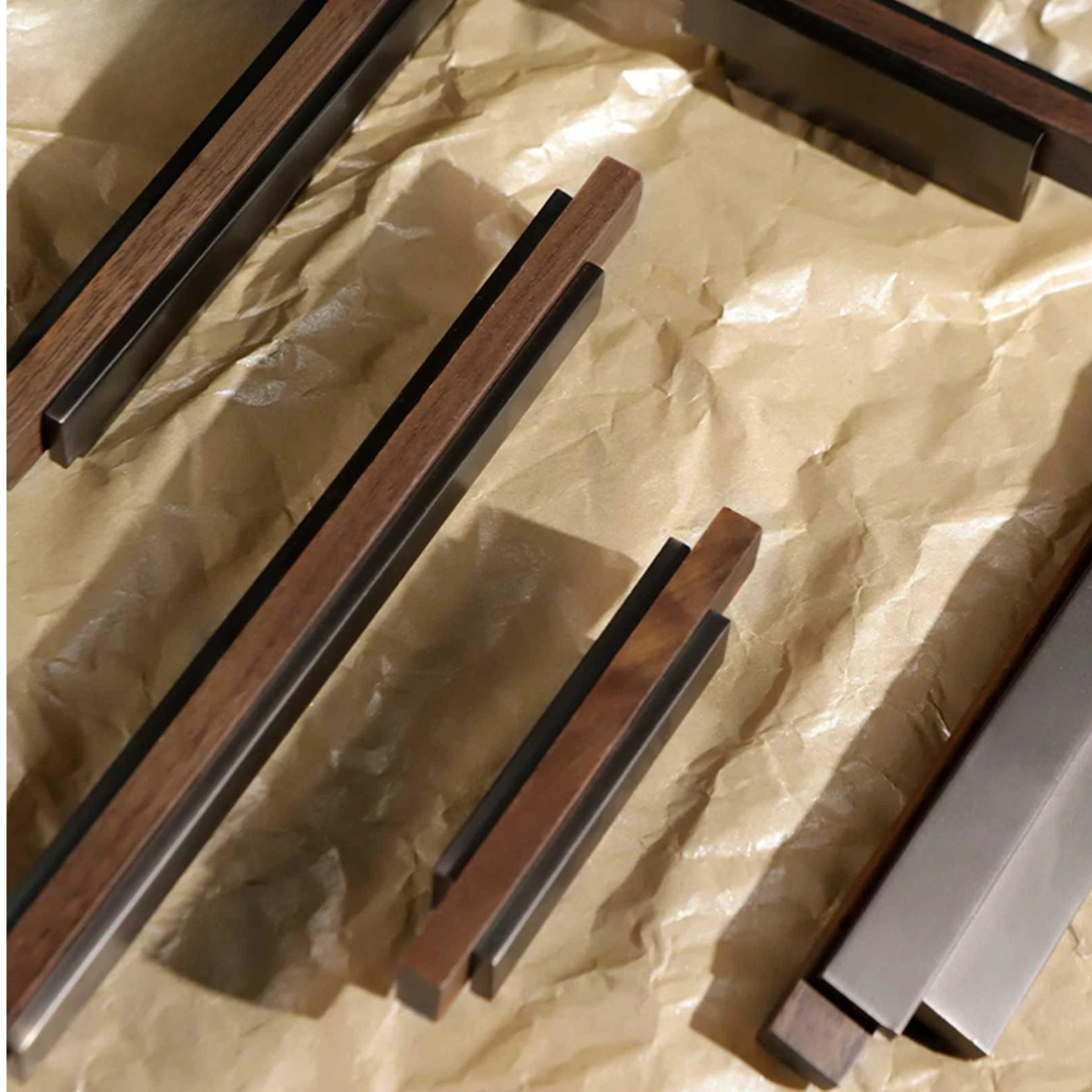 Close-up view of wooden cabinet handles with dark metallic accents, showing fine craftsmanship.