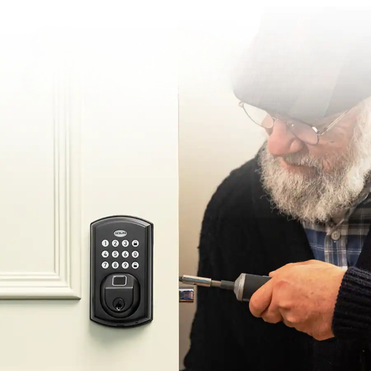 A man installing or adjusting a keypad smart lock on a wooden door.