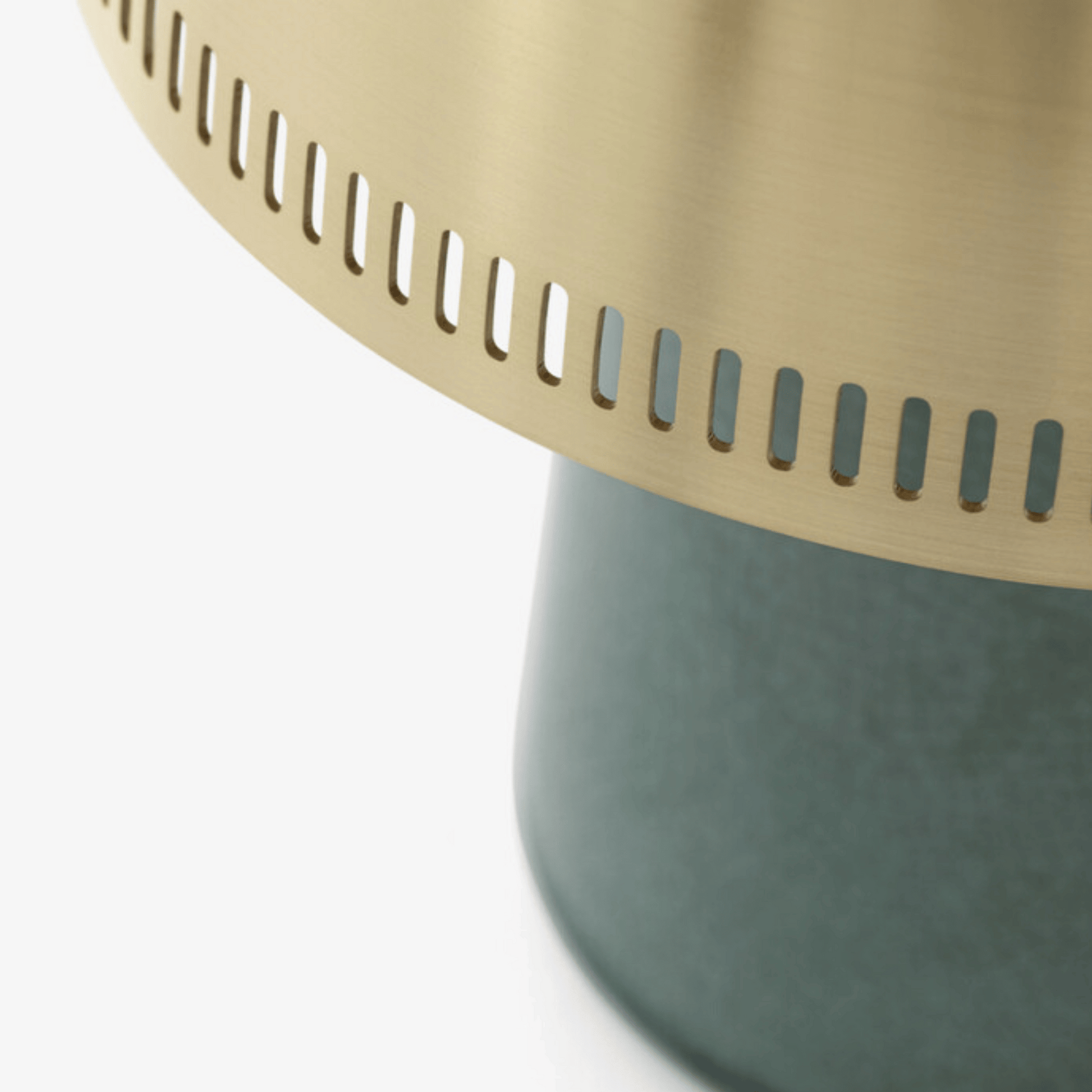 Close-up of a green base with a gold top on a white background