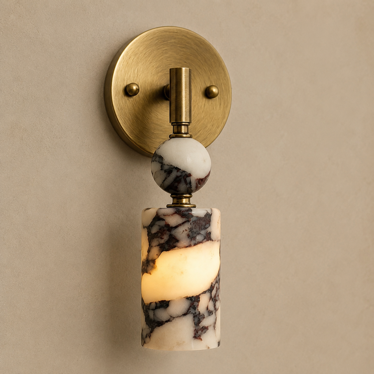Wall sconce with marble-like design and gold fixture on a beige wall