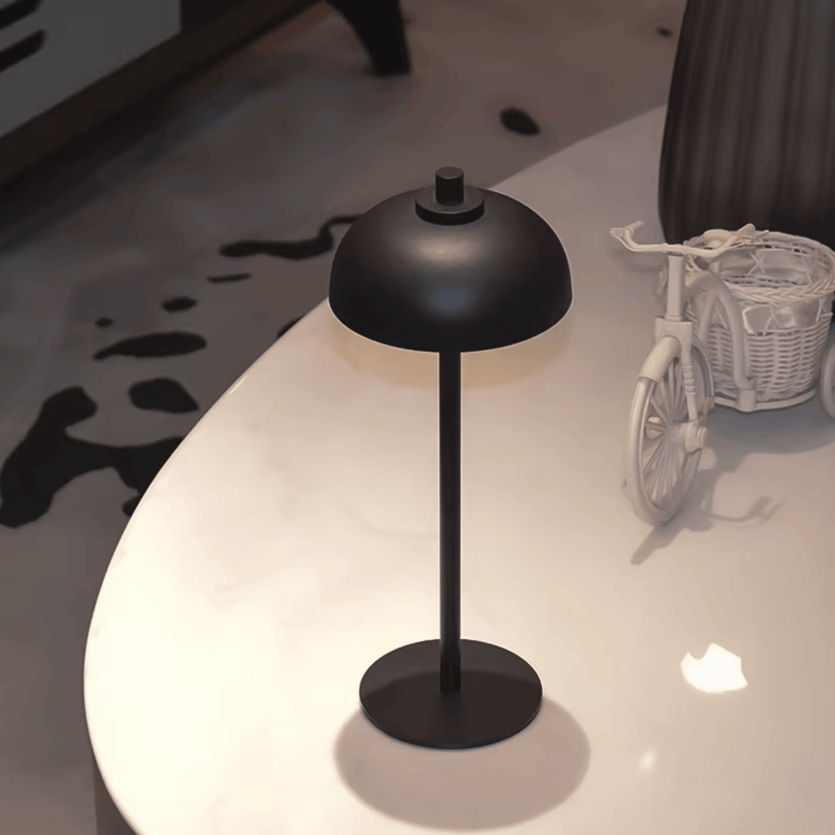 Black table lamp on a white surface with a blurred background