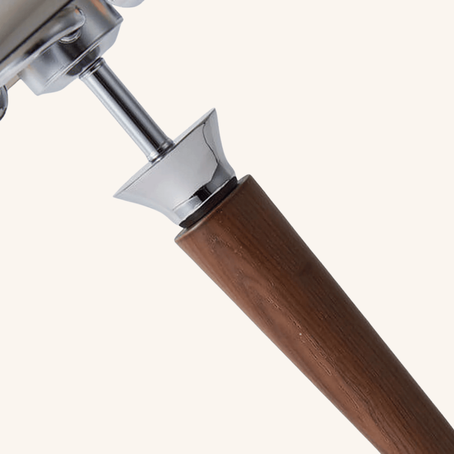 Close-up of a wooden handle with metal ferrule on a white background