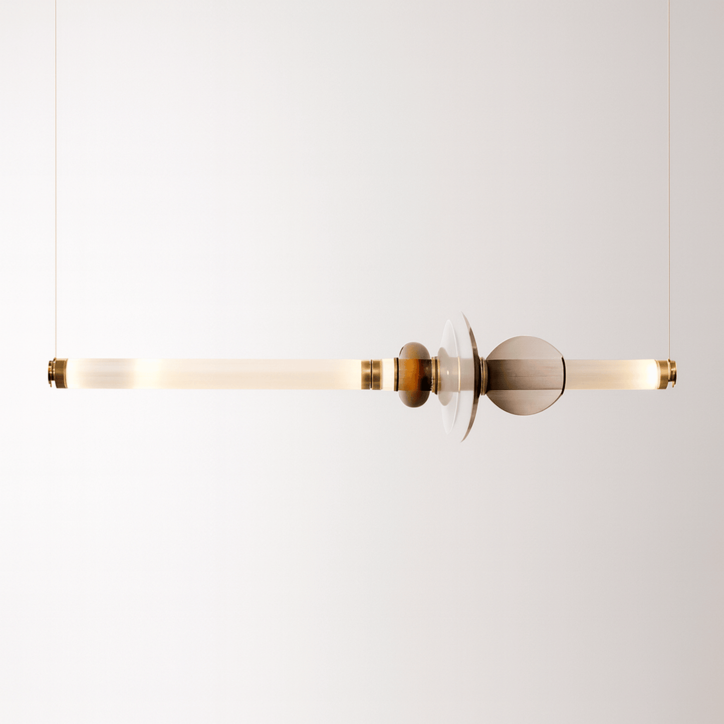 Modern pendant light with gold and glass design on a white background