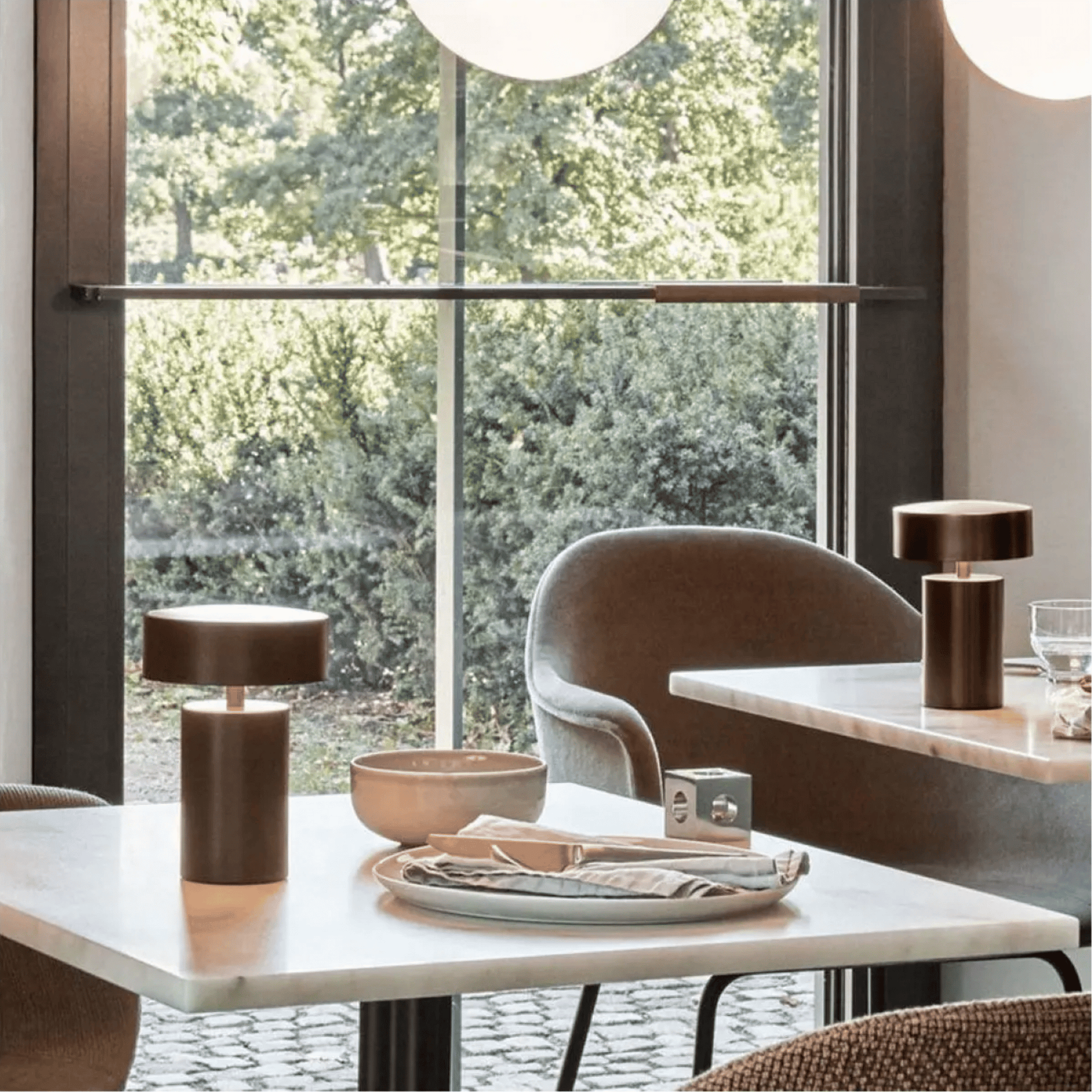 Modern dining room with marble table, chairs, and decorative items.
