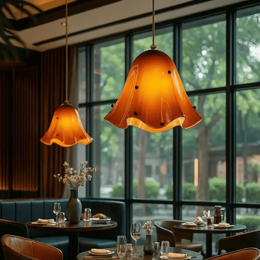 Dining area with orange pendant lights and a view of trees outside.
