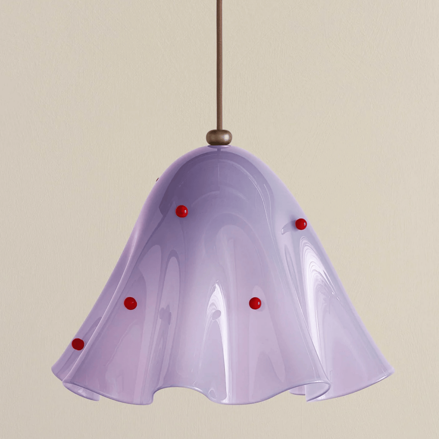 Purple pendant light with red accents on a beige background
