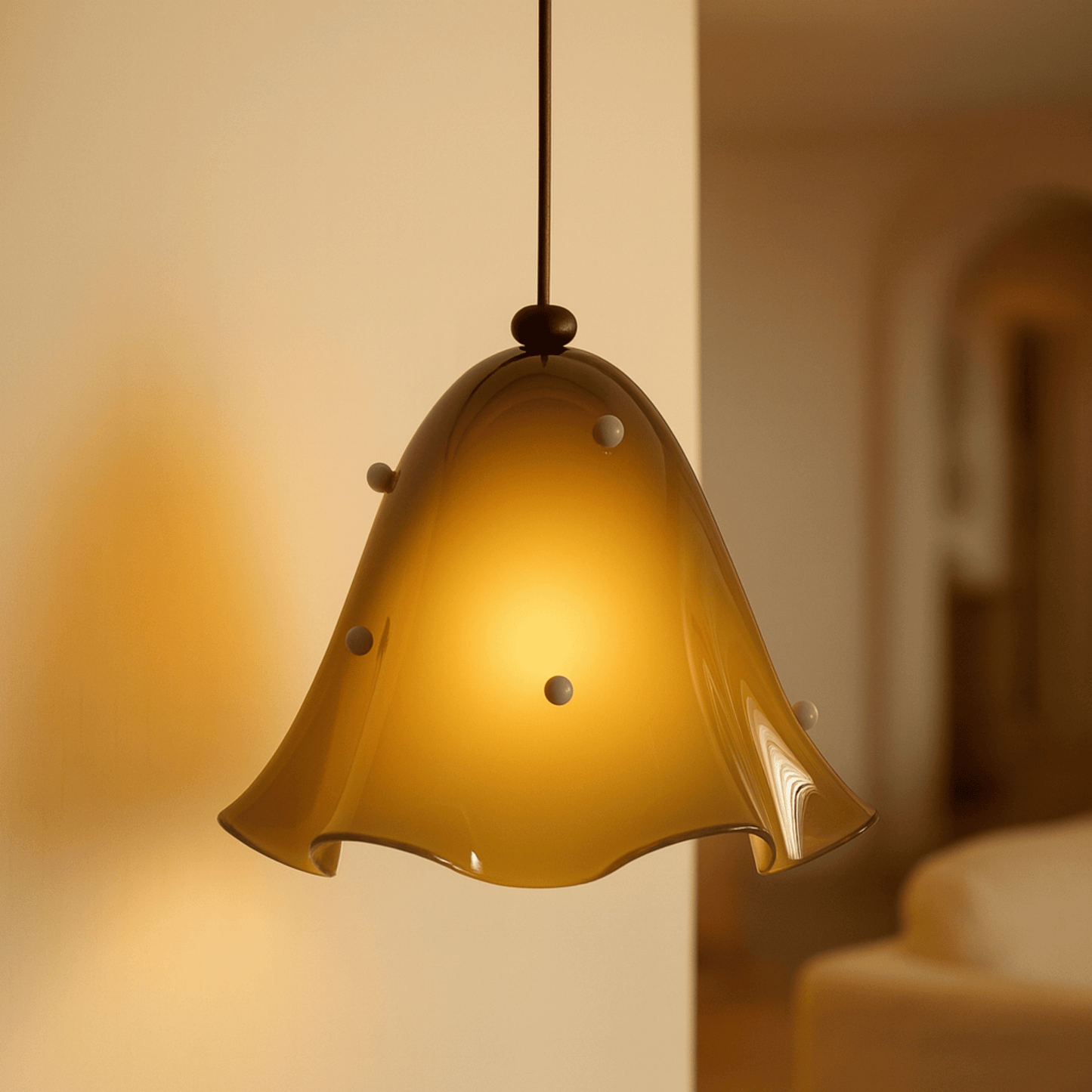 Yellow pendant light hanging against a blurred background