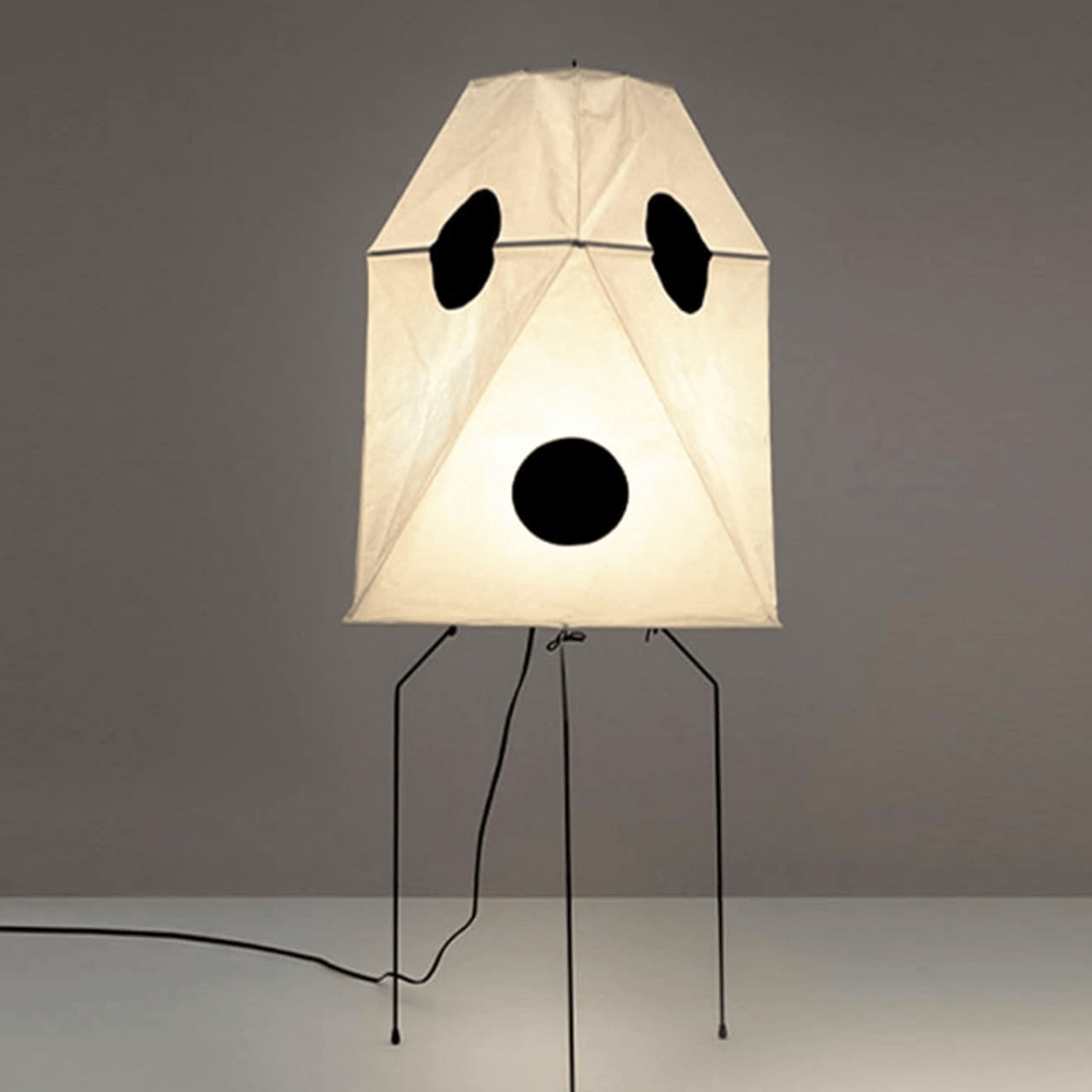 Lamp with panda face design on a gray background