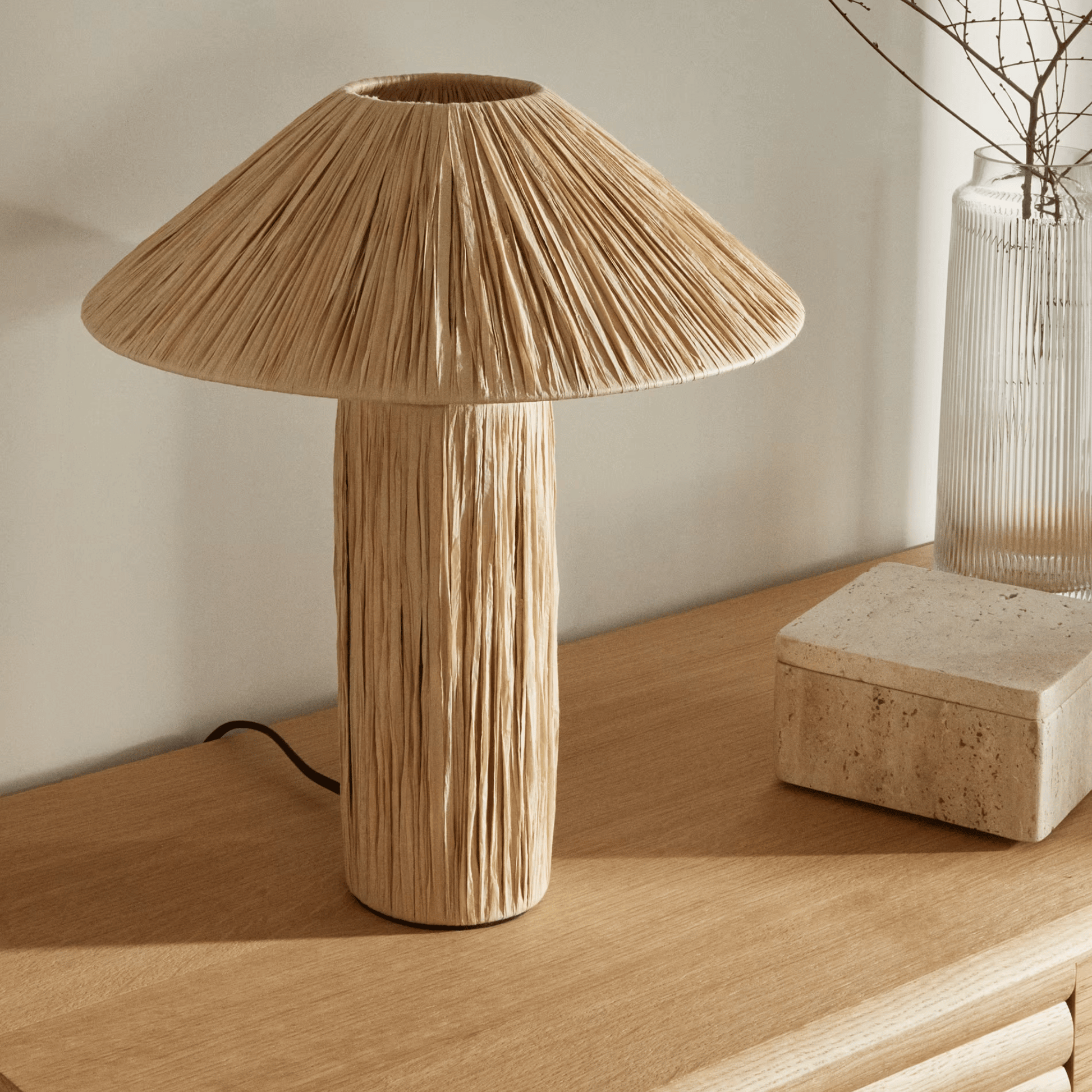 Wooden table lamp on a wooden surface with a neutral background