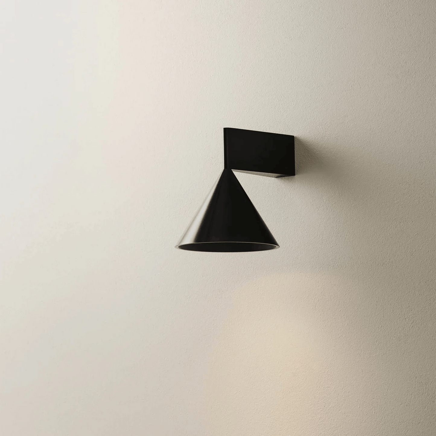 Modern black wall lamp on a neutral beige wall