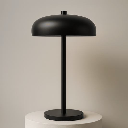 Black table lamp on a stand with a beige backround