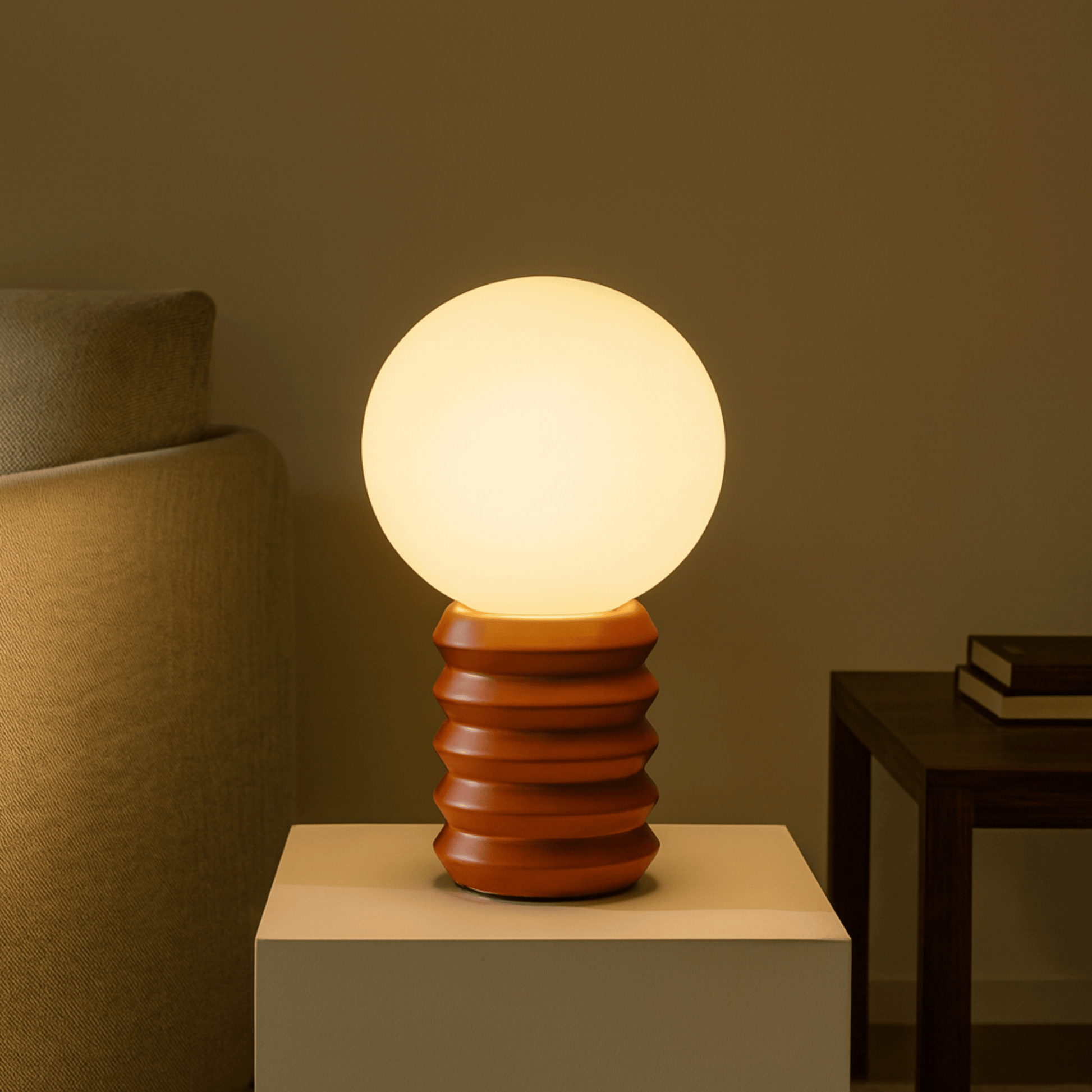 Table lamp with wooden base on a white surface against a brown wall