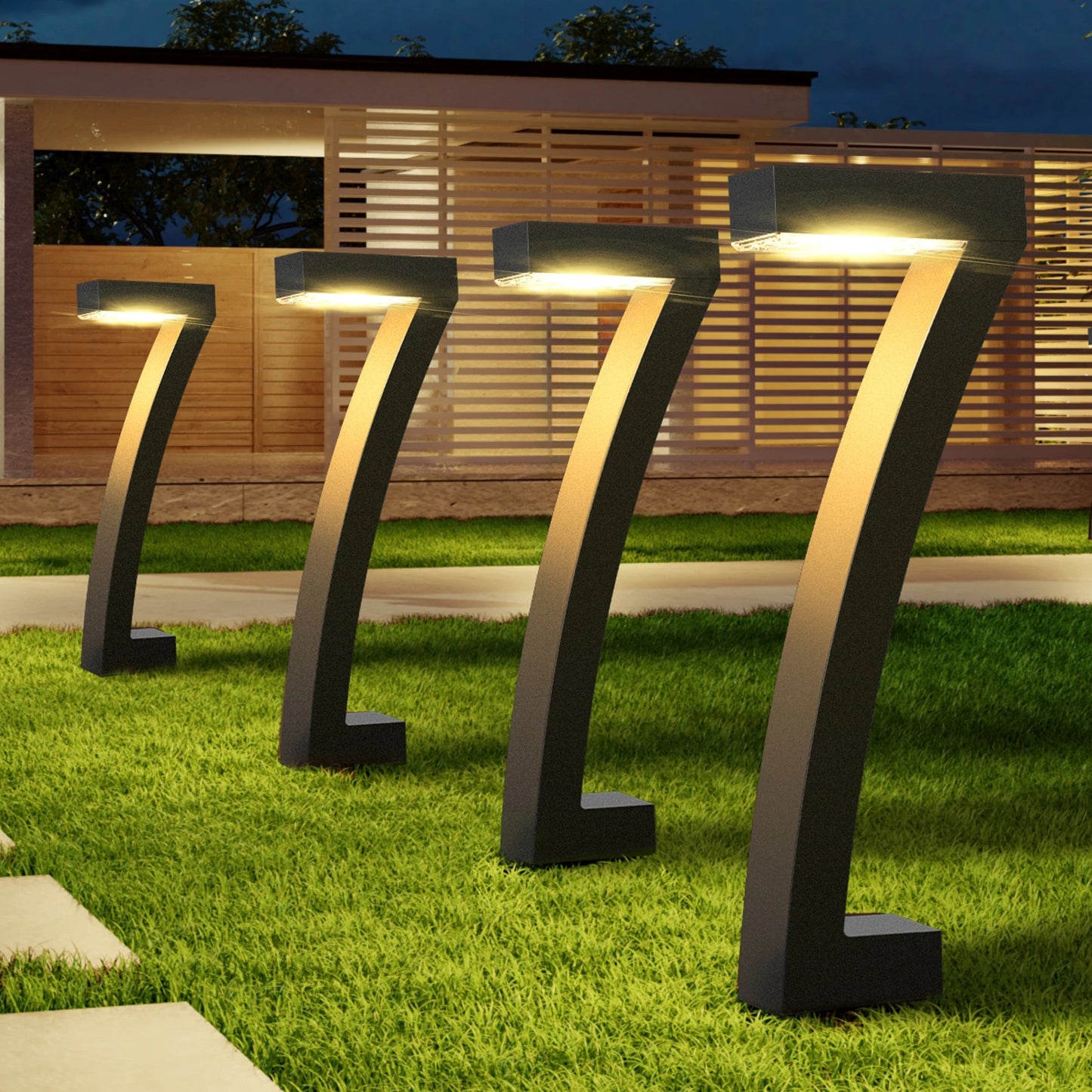 Modern outdoor lamps on grass with a house in the background