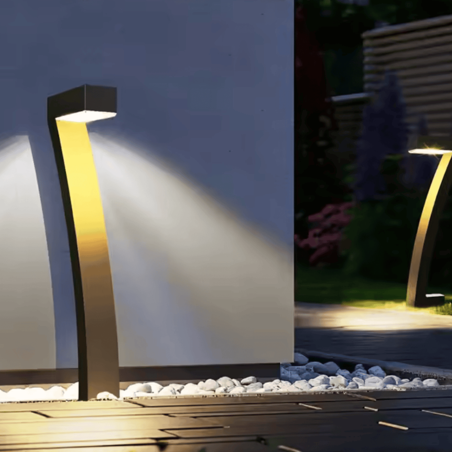 Modern outdoor garden light fixture illuminating a pathway at night.
