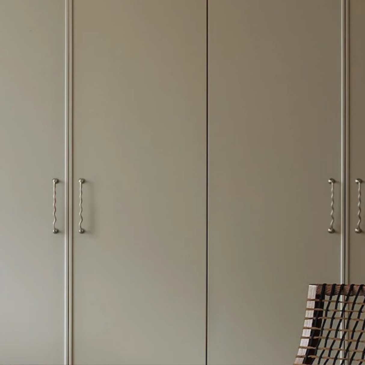 Tall wardrobe doors with matching wavy stainless steel handles