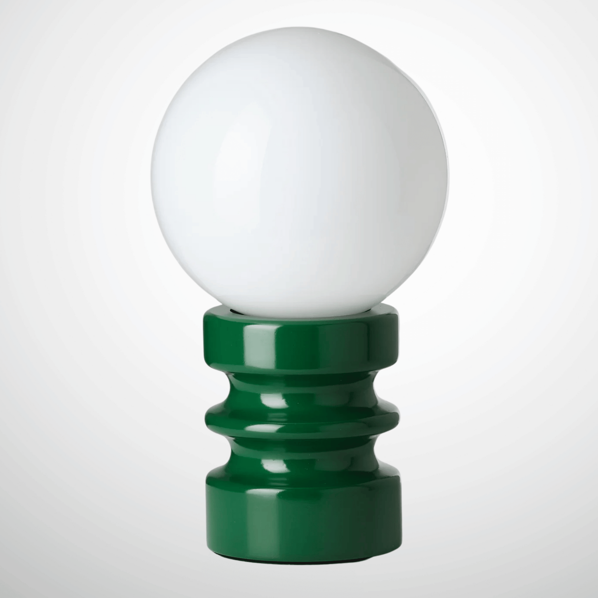 Green lamp finial with a white sphere on a white background
