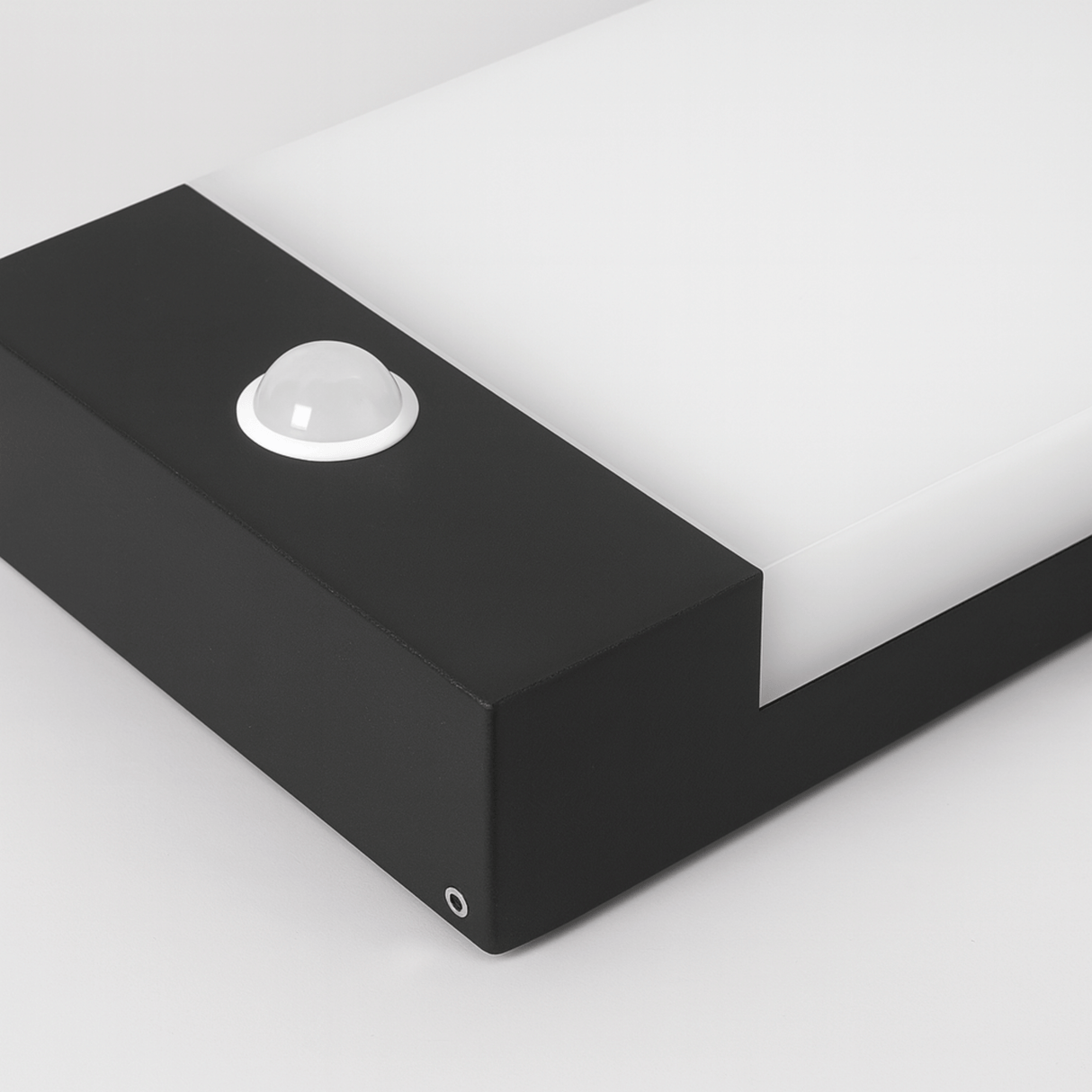Black rectangular light fixture on a white background
