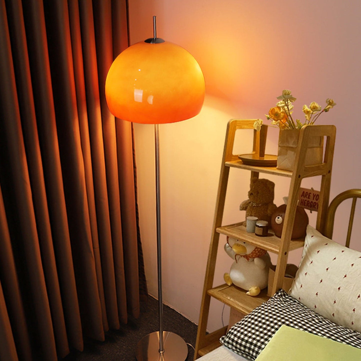 A close-up of a yellow globe-shaped floor lamp, glowing warmly in a modern living room.