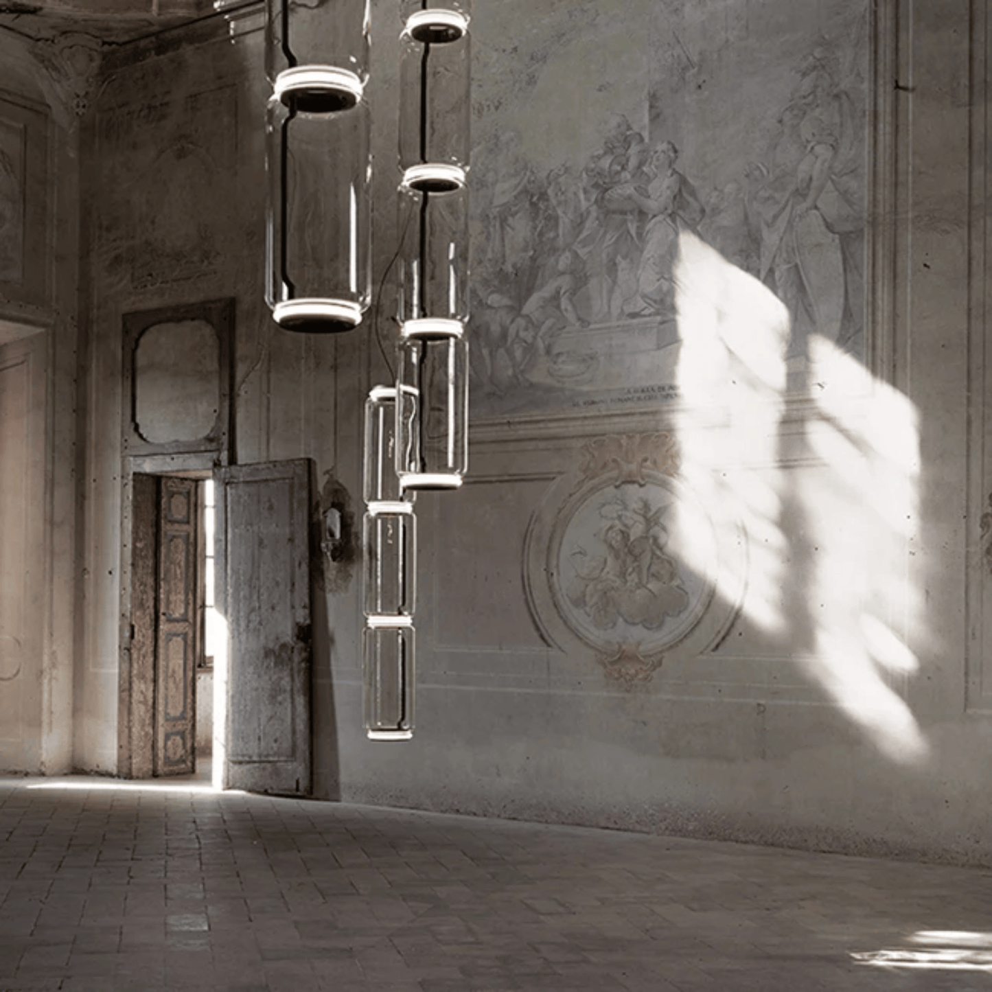 Modern chandelier hanging in a room with classical architecture