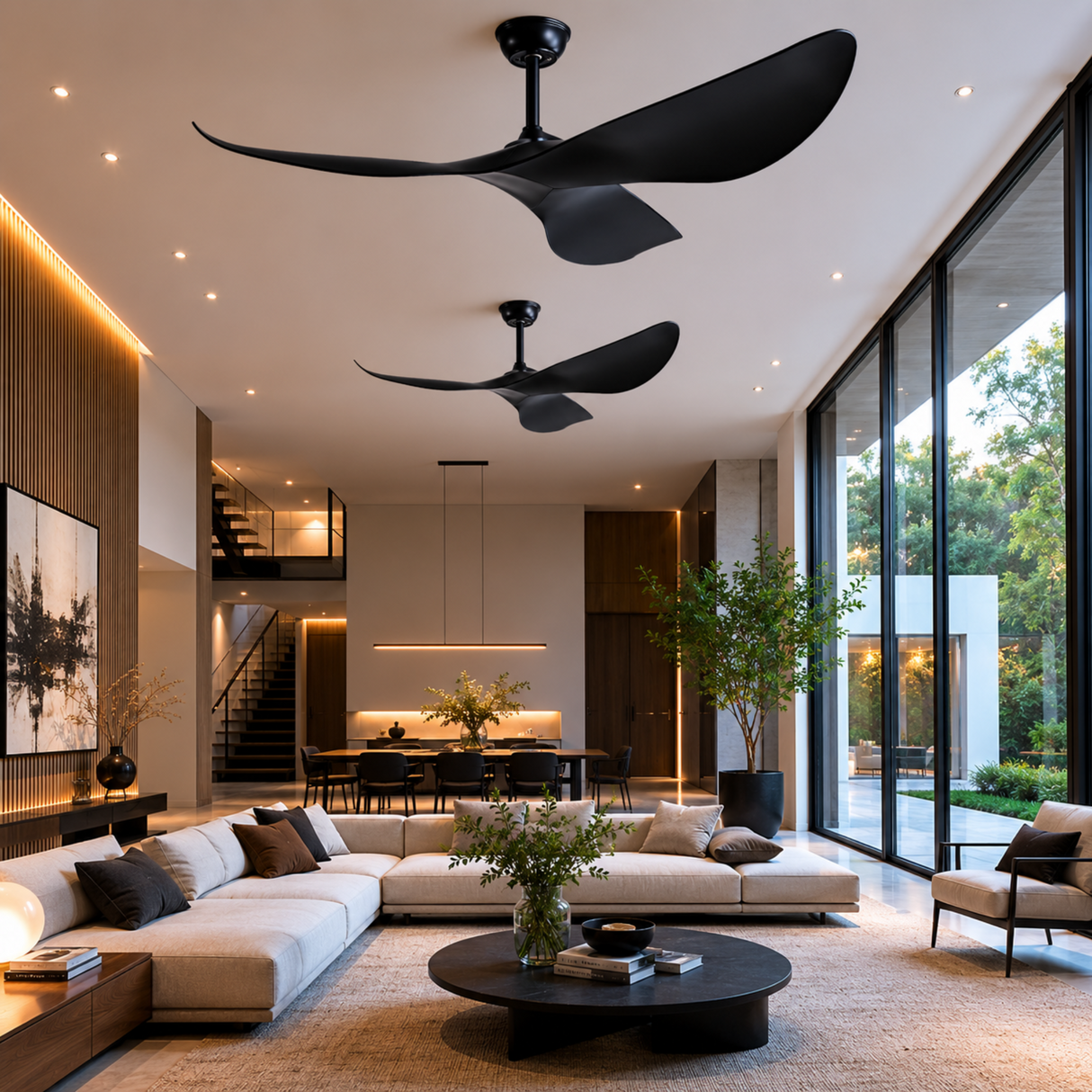 Modern living room with black ceiling fans, large windows, and a stylish sofa.