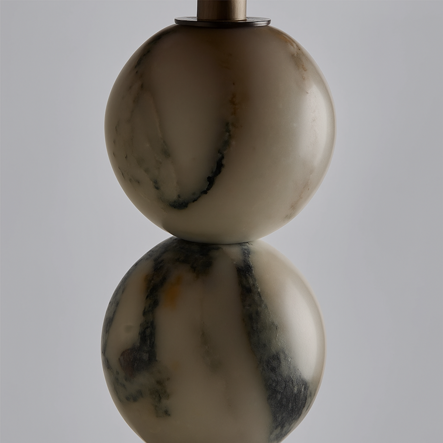 Marble-textured lamp with two spherical shapes on a gray background