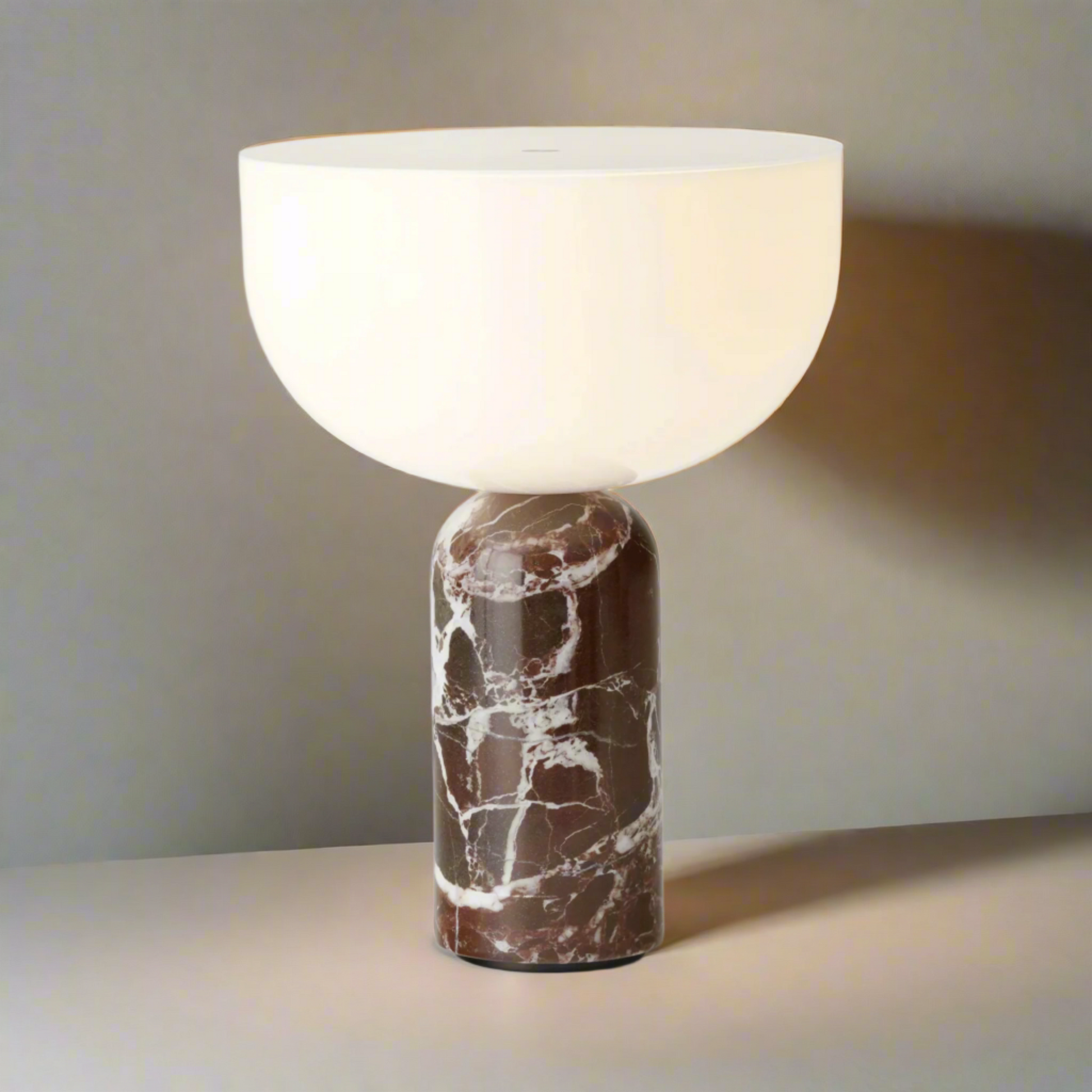 Table lamp with marble base and white shade on a white background