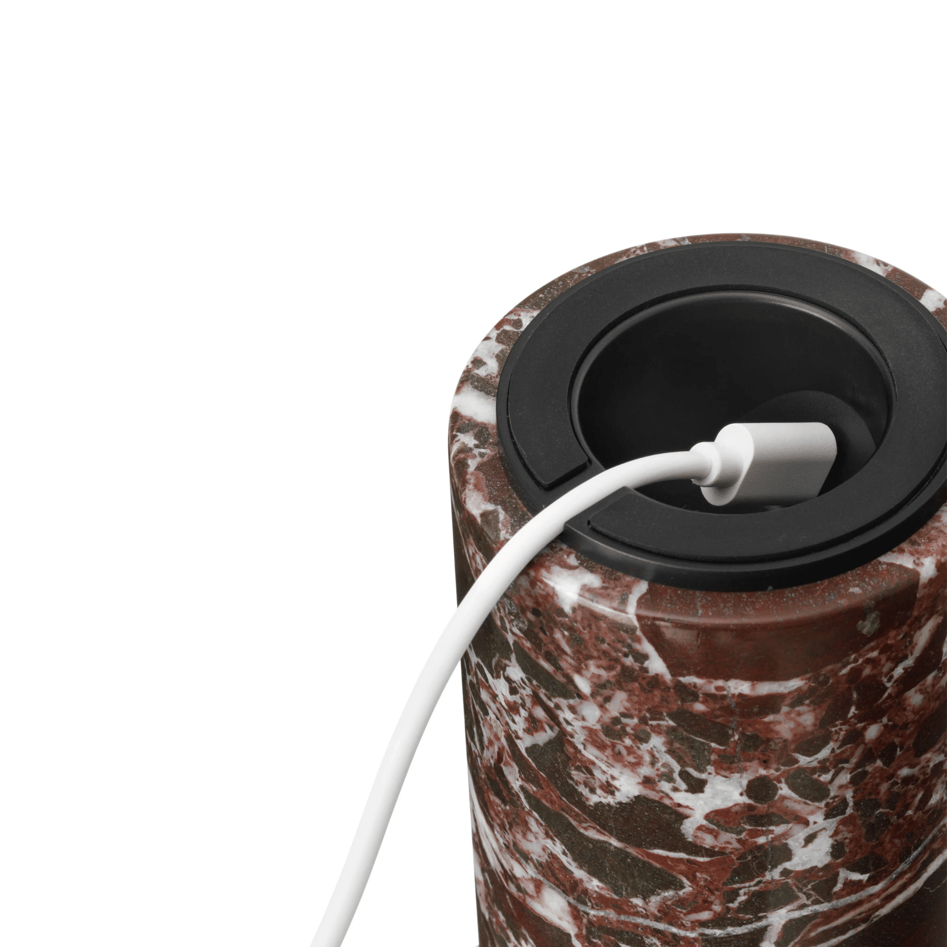 Marble-patterned electronic device with a white cable on a white background