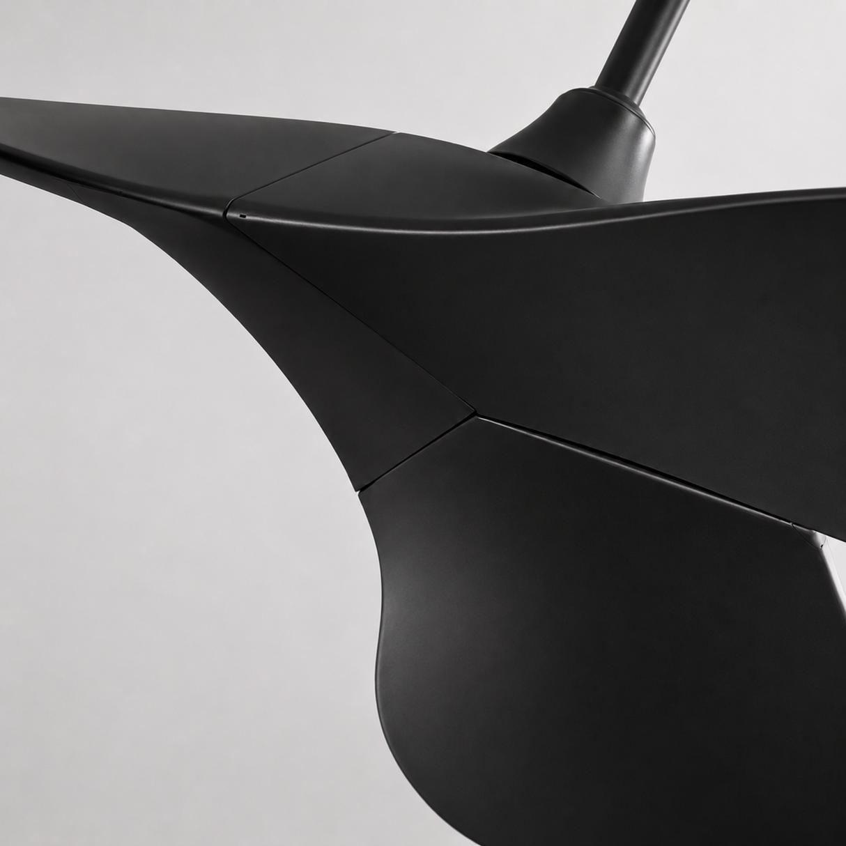 Close-up of a black propeller on a light gray background