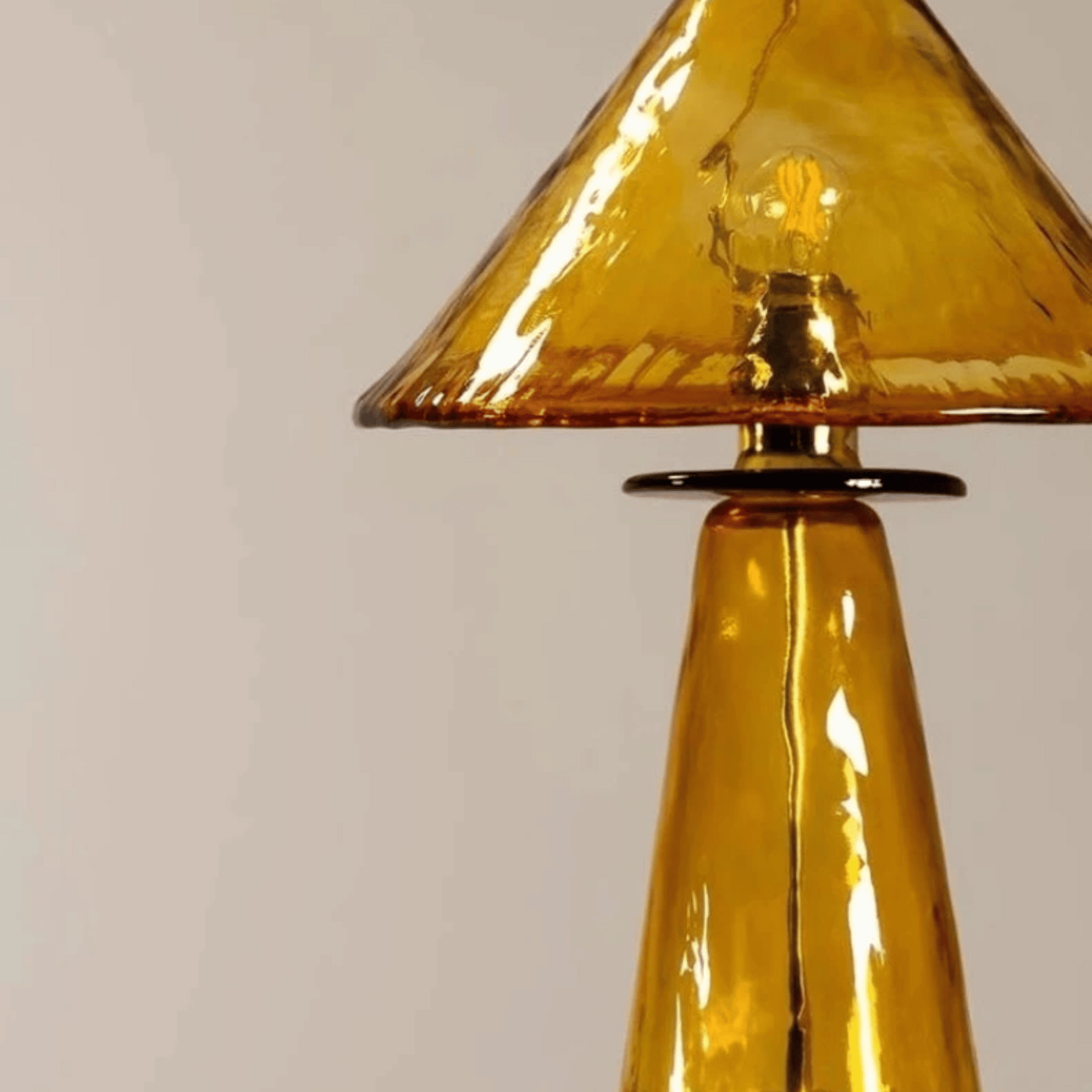 Amber glass lamp on a beige backround